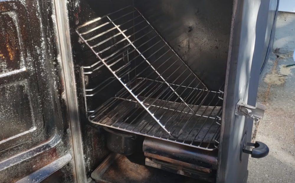 the shelf of a masterbuilt electric smoker propped on its side for beef brisket
