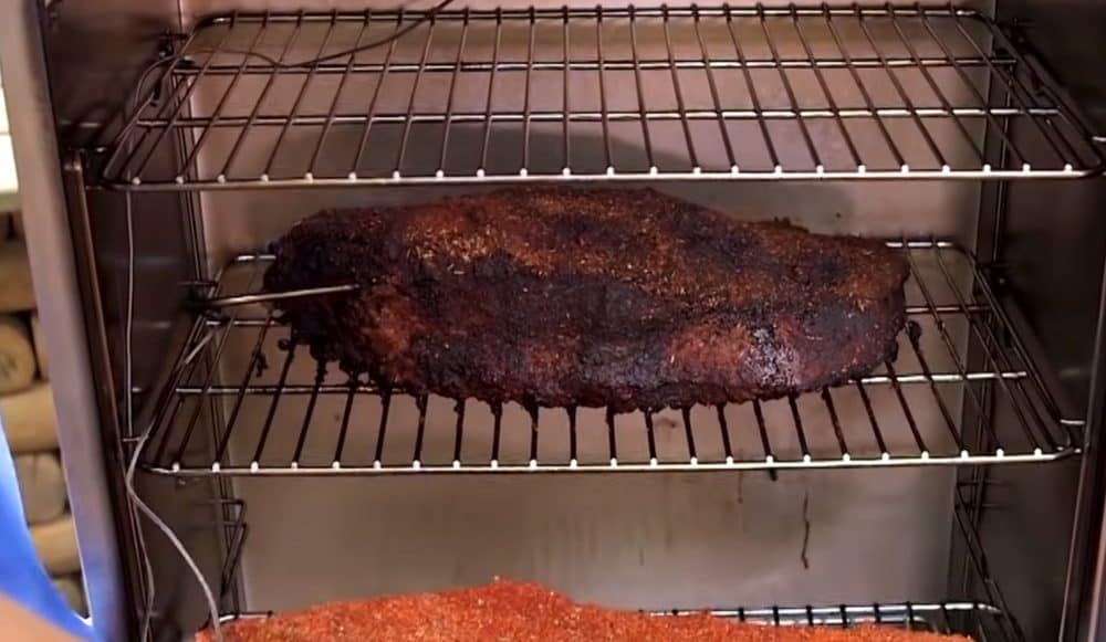 a beef brisket smoking in a masterbuilt electric smoker
