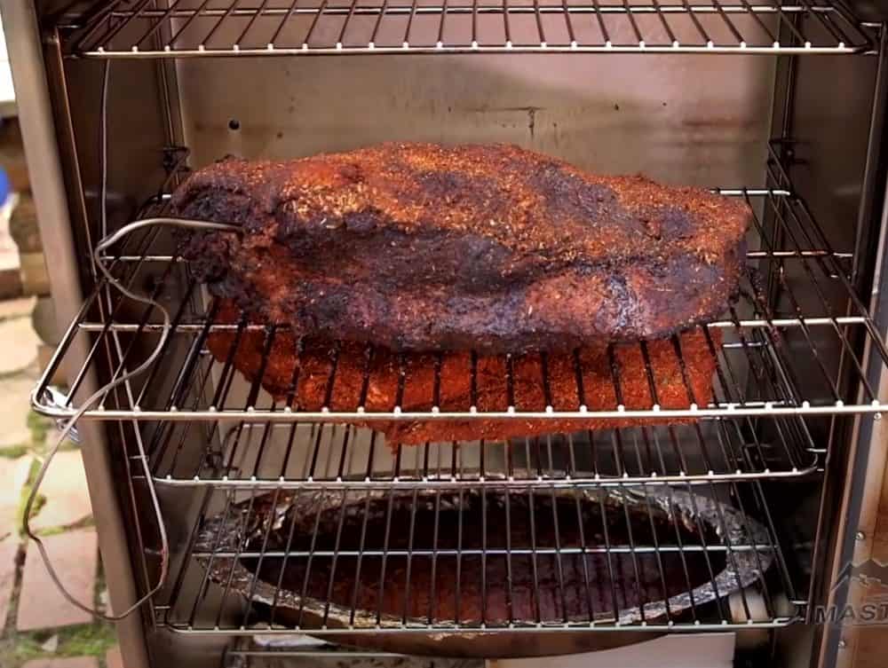 a beef brisket smoking in a masterbuilt electric smoker