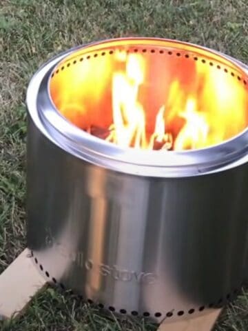 a solo stove set up and being used on grass