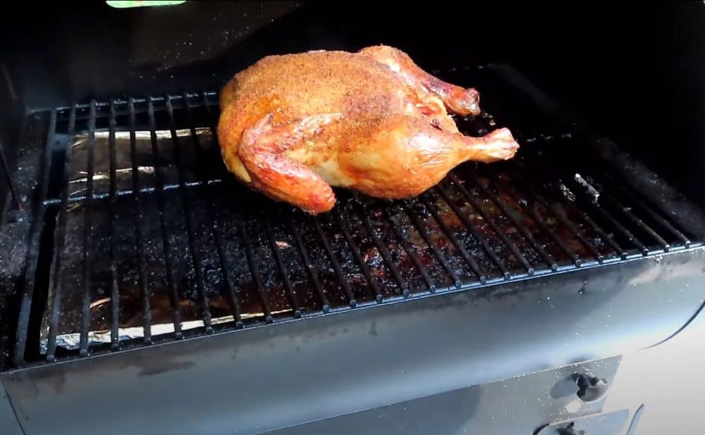 a whole smoked chicken on a traeger pellet grill