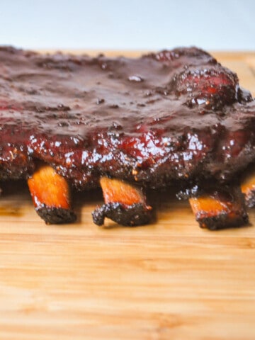 smoked spareribs on a wooden cutting board