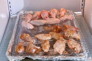 chicken wings on a wire rack in the refrigerator