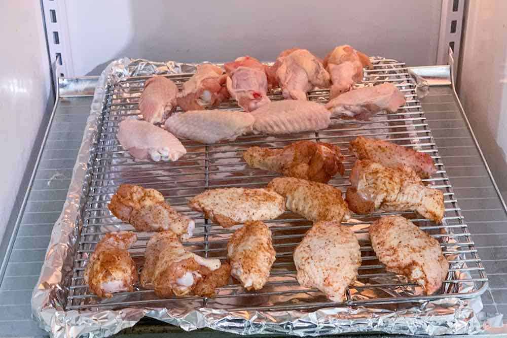 chicken wings on a wire rack in the refrigerator