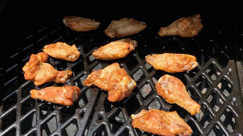 chicken wings cooking over low heat on pellet grill