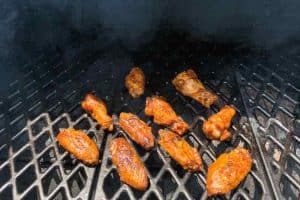 sauced wings cooking on pellet grill