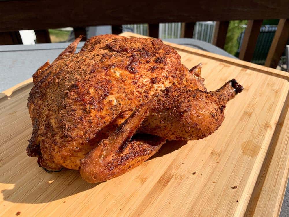 masterbuilt smoked whole chicken on a cutting board