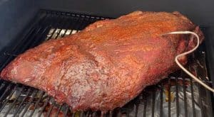 a beef brisket smoking on a camp chef pellet grill