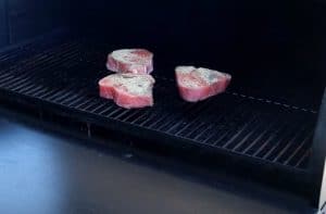 tuna steaks smoking on a traeger pellet grill