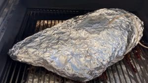 a wrapped brisket on a camp chef pellet grill