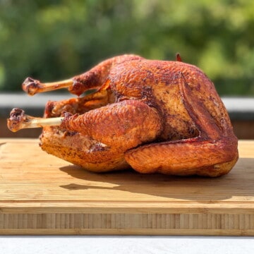 a Whole Smoked Turkey on a cutting board