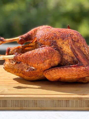 a Whole Smoked Turkey on a cutting board