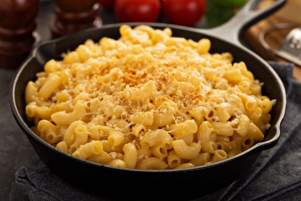 smoked mac and cheese in a cast iron skillet cooked on a pit boss pellet grill