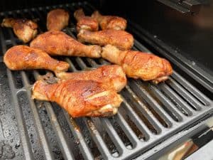 chicken legs smoking on a traeger pellet grill