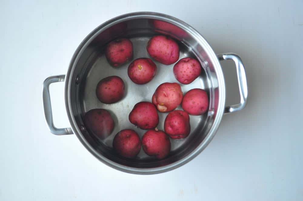 red potatoes boiling in a pot