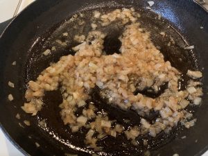 cooking diced onions in a skillet