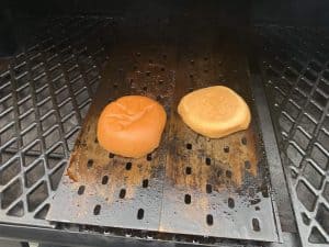 brioche buns toasting on grill grates on pit boss pellet grill