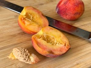 raw peaches sliced in half