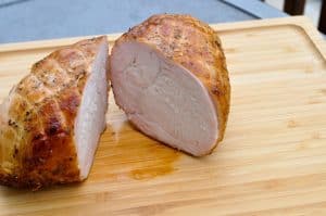 a pit boss smoked boneless turkey breast sliced in half
