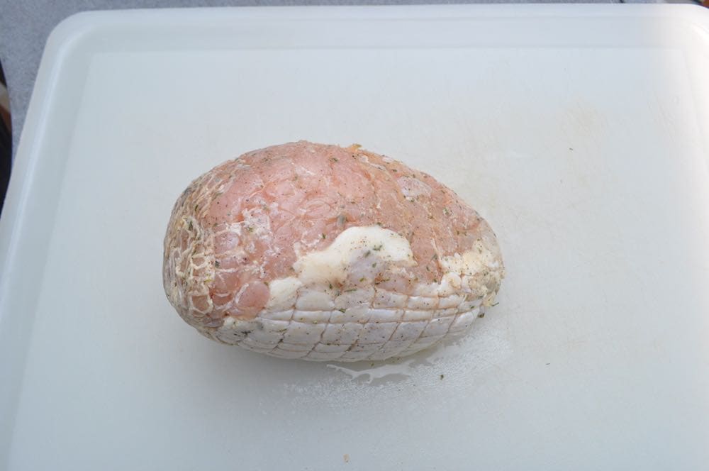 a raw boneless turkey breast on a cutting board