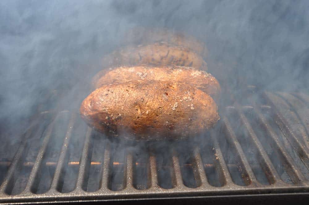 smoked baked potatoes in a smoker