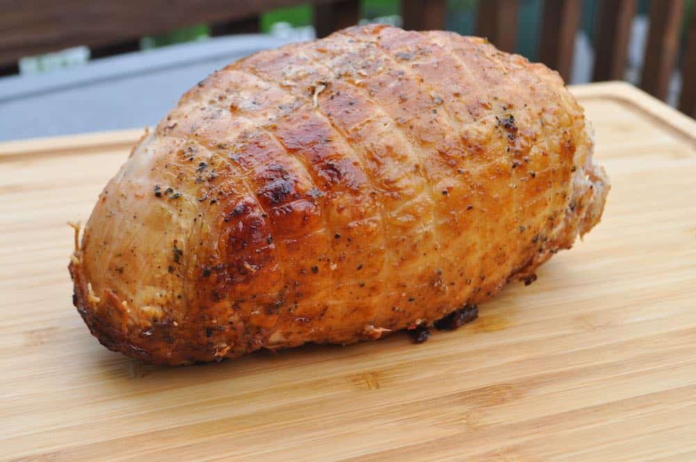 a pit boss smoked turkey breast on a cutting board