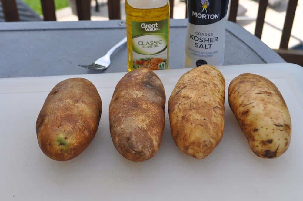 raw potatoes on a cutting board