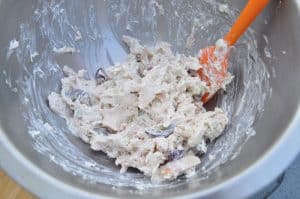 mixing up smoked chicken salad in a bowl