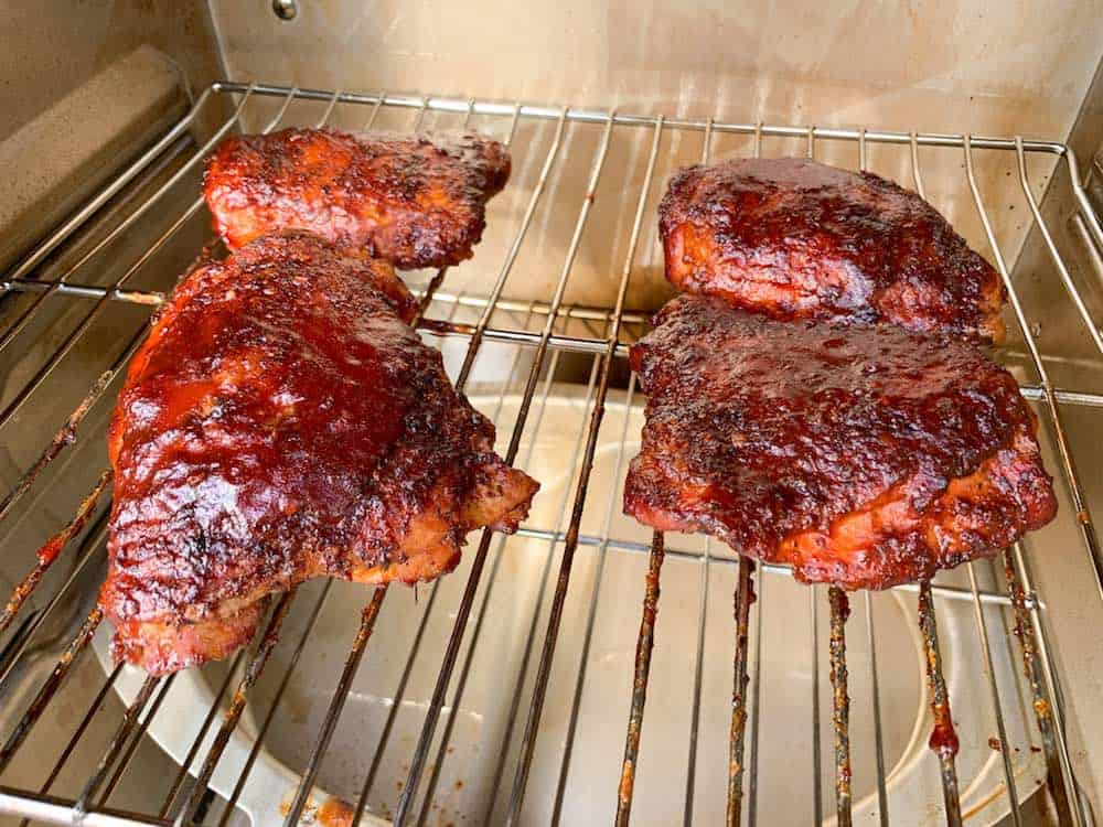 smoked chicken thighs in an electric smoker