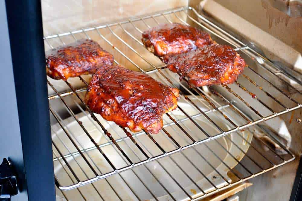 smoked chicken thighs in an electric smoker