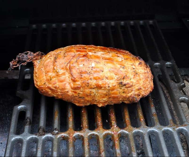 a boneless turkey breast smoking on a traeger pellet grill