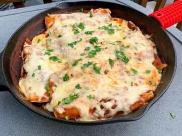 smoked chicken enchiladas in a cast iron skillet