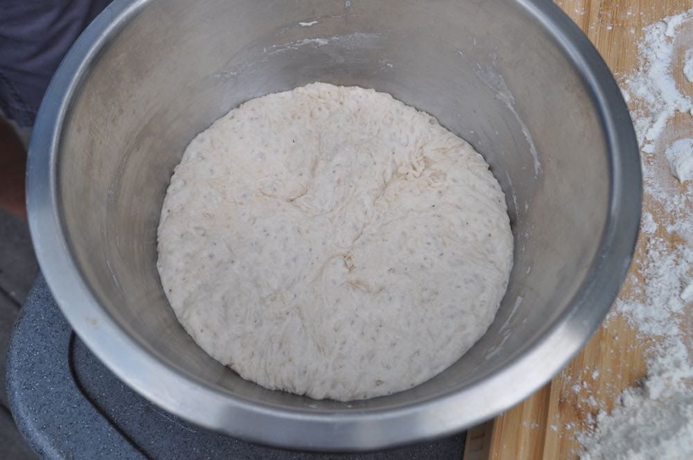 pizza dough rising in a bowl to make smoked pizza