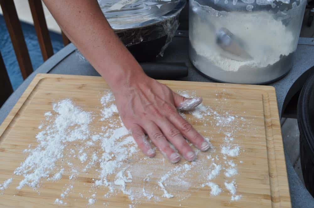 spreading flour on a cutting board