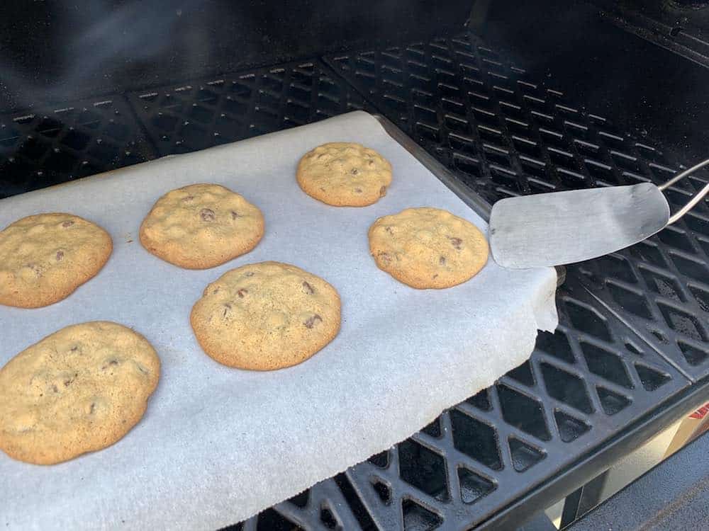 removing smoked chocolate chip cookies with a spatula