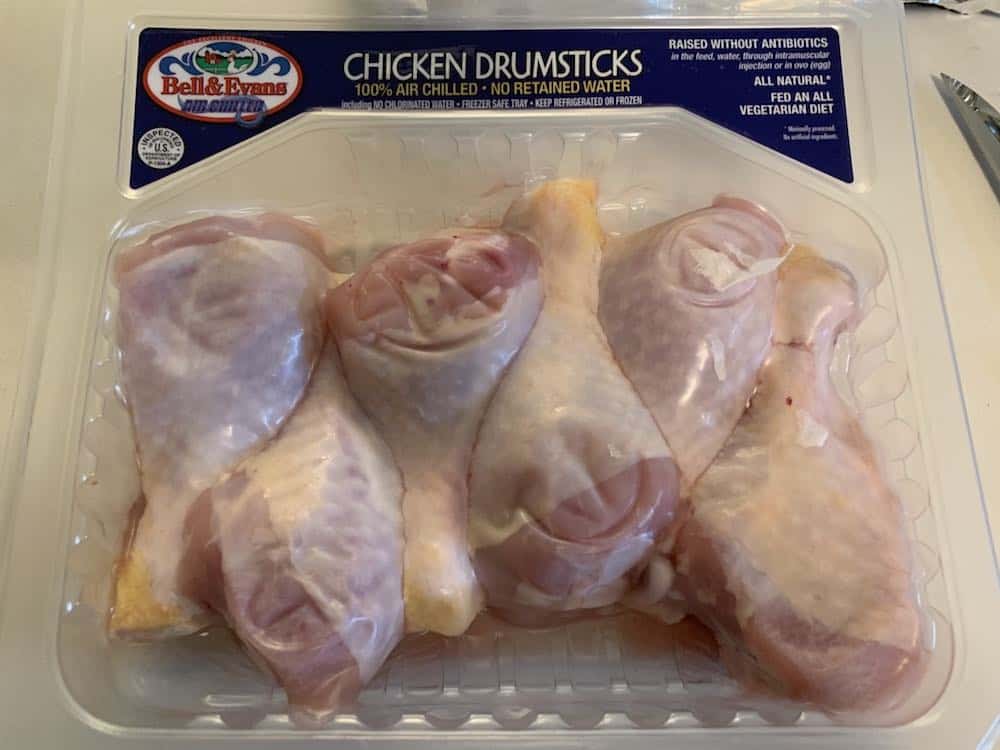 raw chicken legs in a package