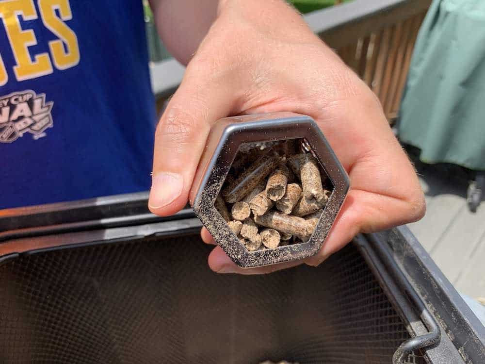 filling a pellet tube smoker with pellets