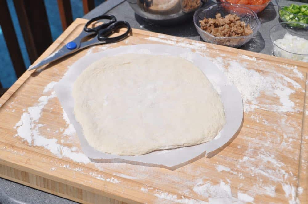 pizza dough with parchment paper cut