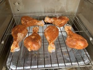 chicken legs placed in an electric smoker
