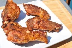 smoked turkey wings on a plate with crispy skin