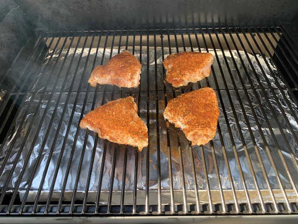 chicken thighs smoking on a z grills pellet grill