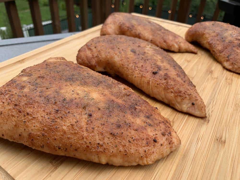 smoked turkey tenderloins on a cutting board