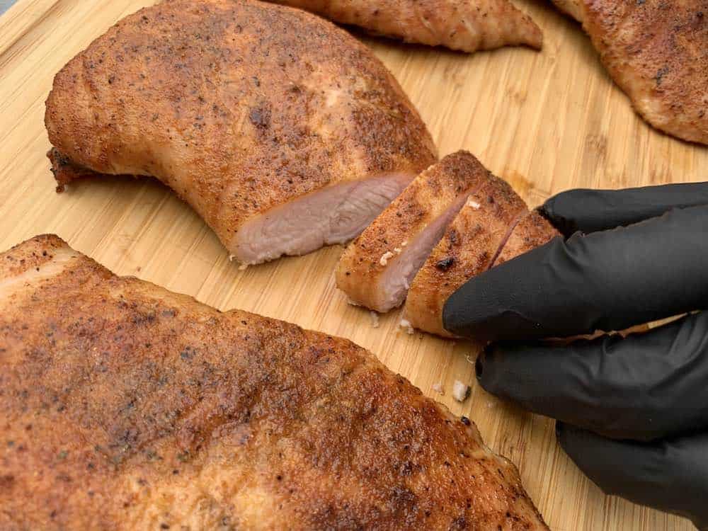 slicing a smoked turkey tenderloin