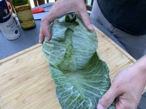 removing the outer leaves from a head of cabbage