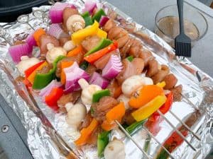 raw chicken kabobs on a tray before smoking