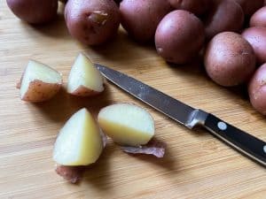 quartered red potato on a cutting board