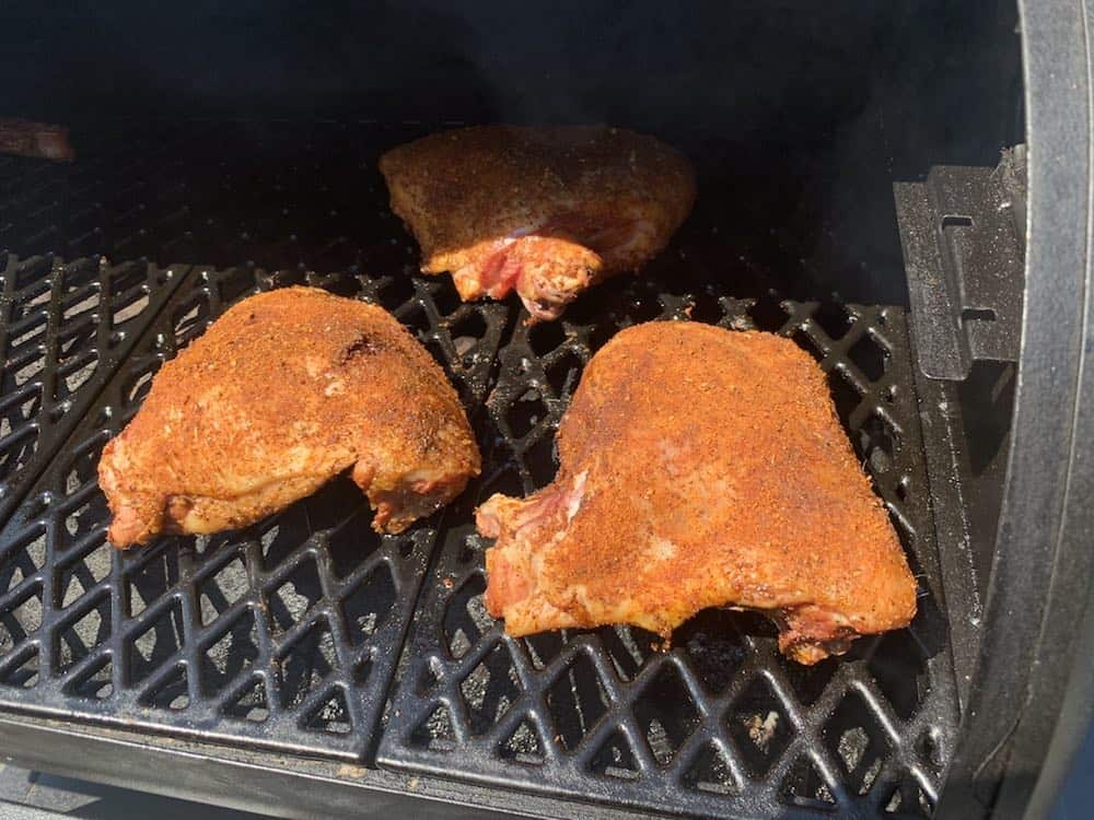 turkey thighs placed in a smoker