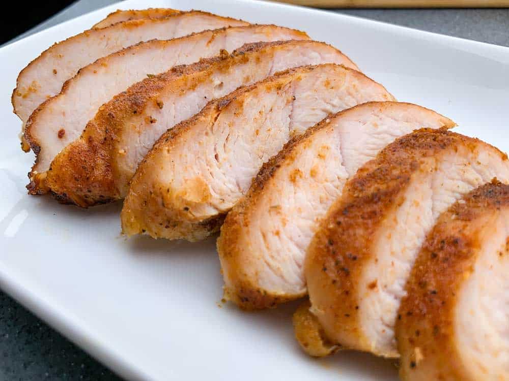 smoked turkey tenderloin sliced on a plate