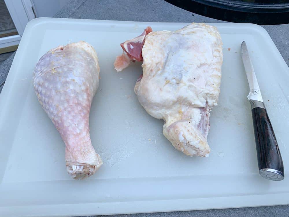 a raw turkey thigh and turkey leg separated