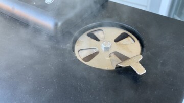 smoke coming out the top vent of an electric smoker